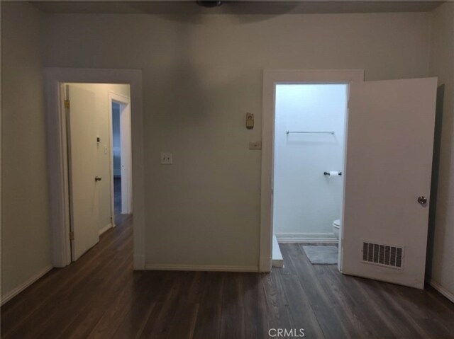 corridor featuring dark wood-type flooring