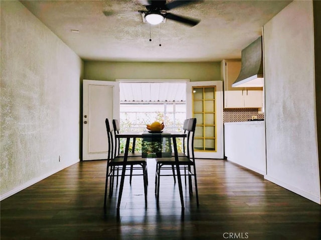 dining area featuring dark hardwood / wood-style floors and ceiling fan