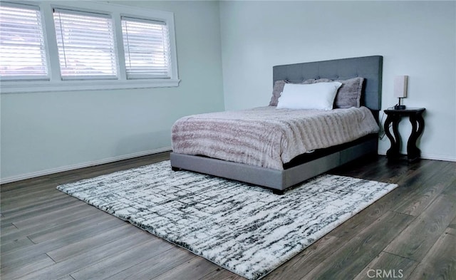 bedroom with dark hardwood / wood-style flooring