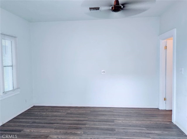 unfurnished room featuring plenty of natural light and dark hardwood / wood-style flooring