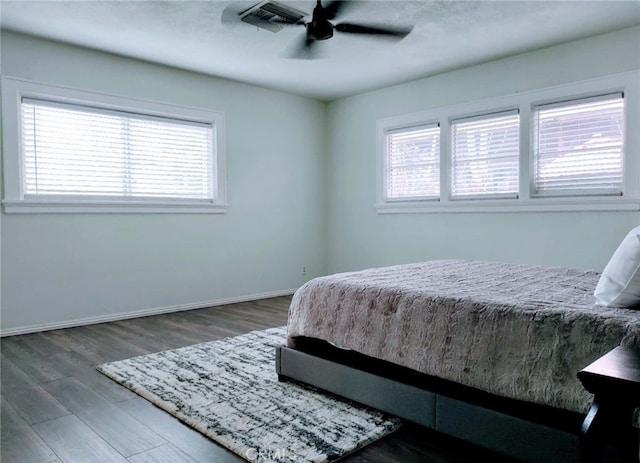 bedroom featuring dark hardwood / wood-style floors and ceiling fan