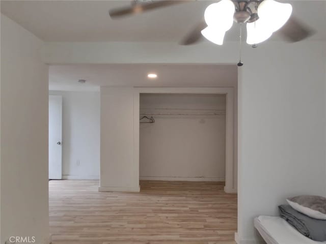 interior space featuring ceiling fan, a closet, and light hardwood / wood-style flooring