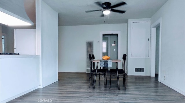 dining room with dark wood-type flooring and ceiling fan