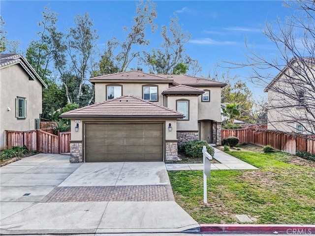 view of front of home with a garage and a front lawn