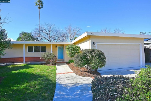 ranch-style house with a garage and a front yard