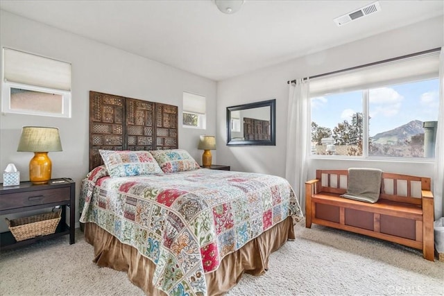 bedroom featuring light colored carpet