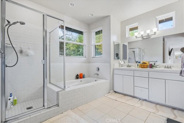 bathroom with tile patterned floors, shower with separate bathtub, and vanity