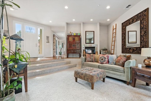 living room with a tile fireplace