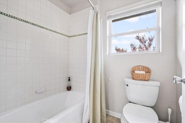 bathroom with toilet and shower / bath combo with shower curtain