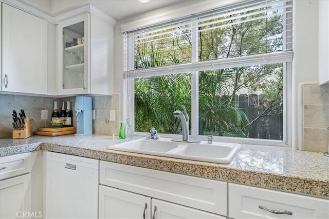 kitchen featuring white cabinetry, sink, and white dishwasher