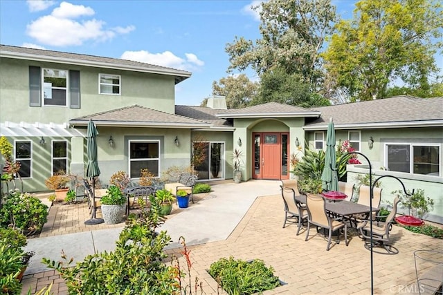 view of front of house with a pergola and a patio area