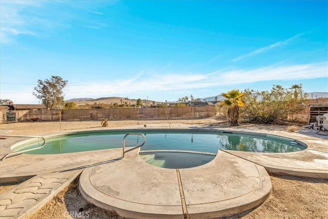 view of swimming pool with a mountain view