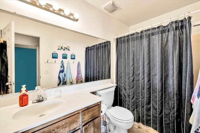 bathroom featuring vanity and toilet