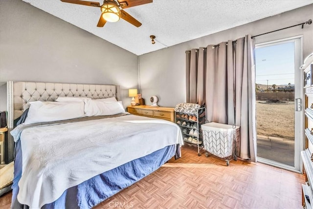 bedroom featuring lofted ceiling, ceiling fan, light parquet floors, a textured ceiling, and access to outside