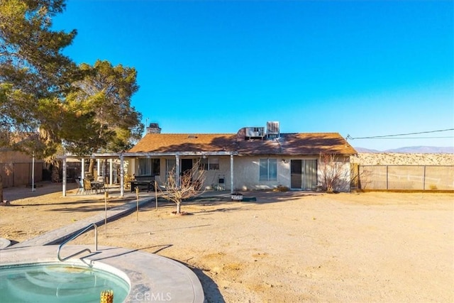 rear view of property featuring a mountain view and a patio