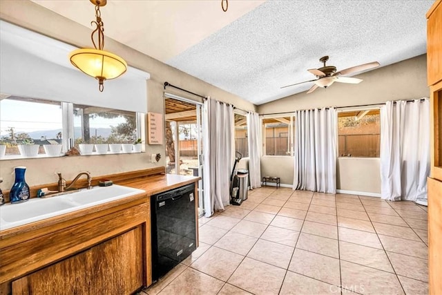 kitchen with sink, decorative light fixtures, vaulted ceiling, light tile patterned floors, and black dishwasher