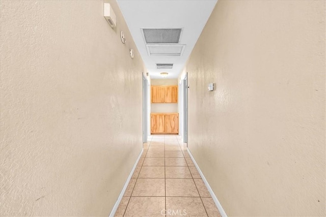 corridor featuring light tile patterned flooring