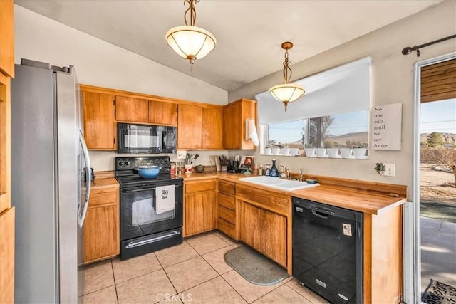 kitchen featuring sink, hanging light fixtures, light tile patterned floors, plenty of natural light, and black appliances