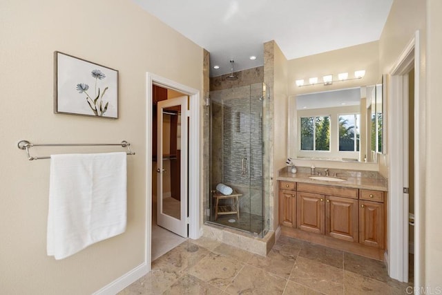 bathroom with vanity and a shower with shower door