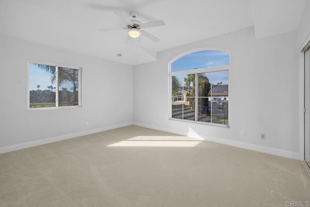 carpeted spare room with ceiling fan