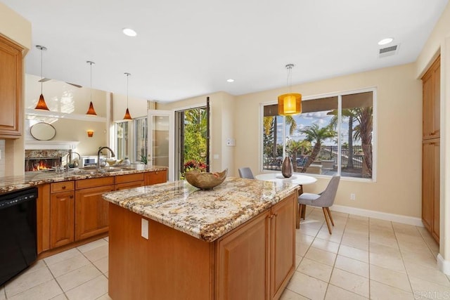 kitchen featuring light tile patterned floors, black dishwasher, light stone countertops, a kitchen island, and decorative light fixtures