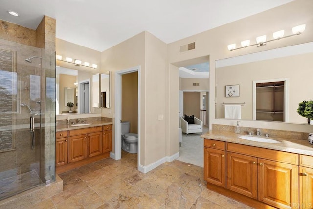 bathroom featuring vanity, toilet, and walk in shower