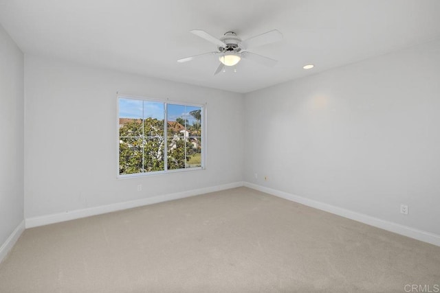 empty room with ceiling fan and carpet flooring