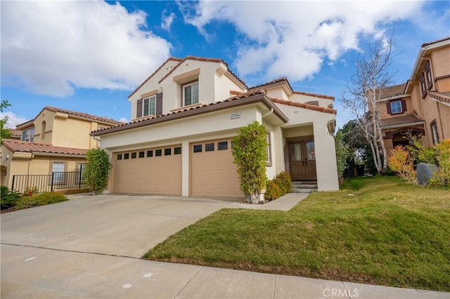 mediterranean / spanish house with a garage and a front lawn