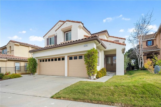 mediterranean / spanish-style home with a tiled roof, a front yard, stucco siding, a garage, and driveway