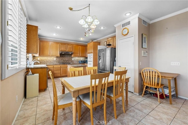 dining area with a notable chandelier, light tile patterned floors, crown molding, and visible vents