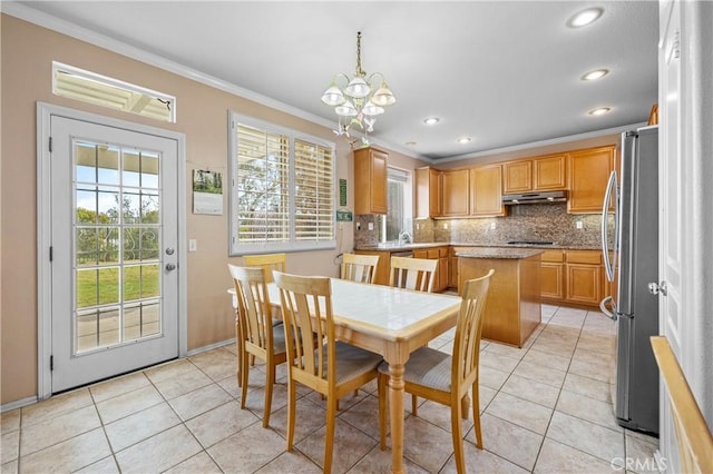 dining space with an inviting chandelier, crown molding, light tile patterned floors, and recessed lighting