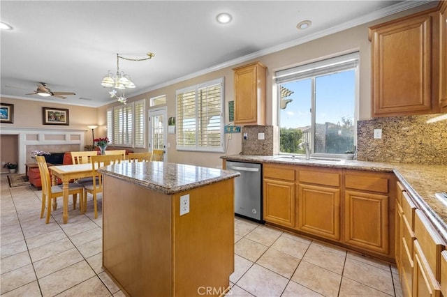 kitchen with crown molding, dishwasher, sink, and pendant lighting