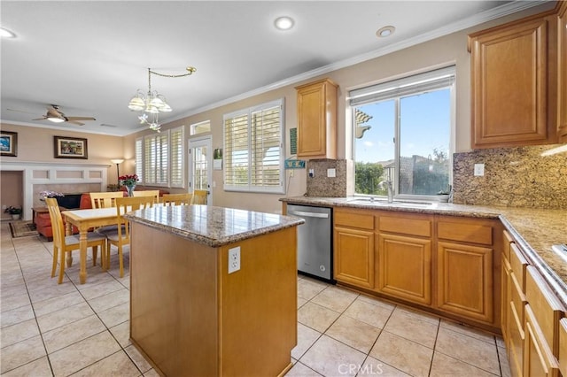 kitchen featuring a sink, a kitchen island, stainless steel dishwasher, open floor plan, and crown molding