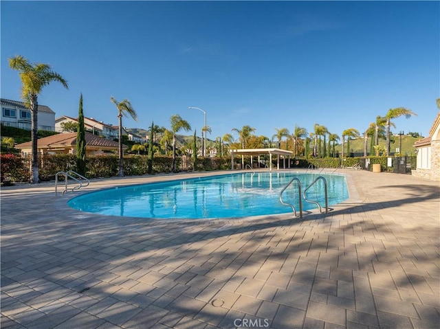 pool featuring a patio area and fence