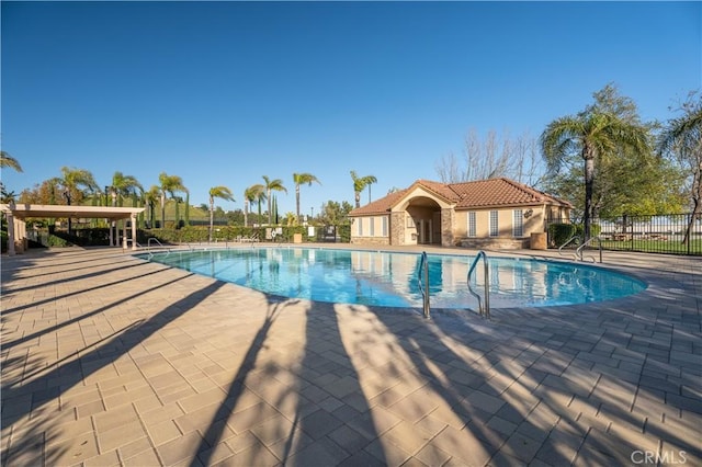 pool featuring a patio area and fence