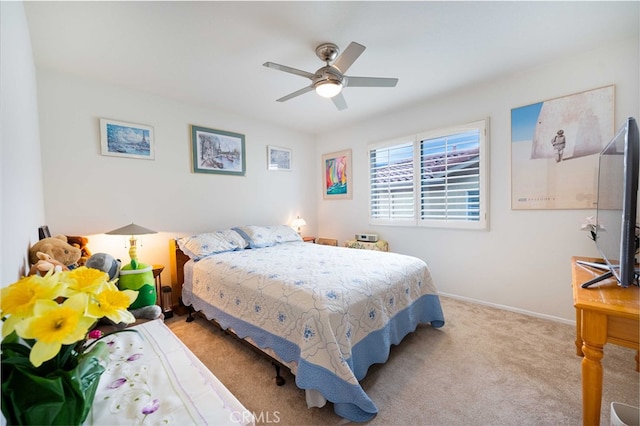 carpeted bedroom featuring baseboards and ceiling fan