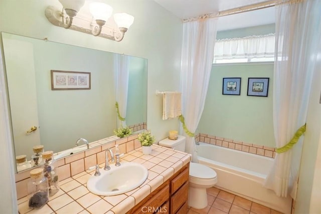 bathroom featuring a chandelier, vanity, tile patterned floors, a tub, and toilet