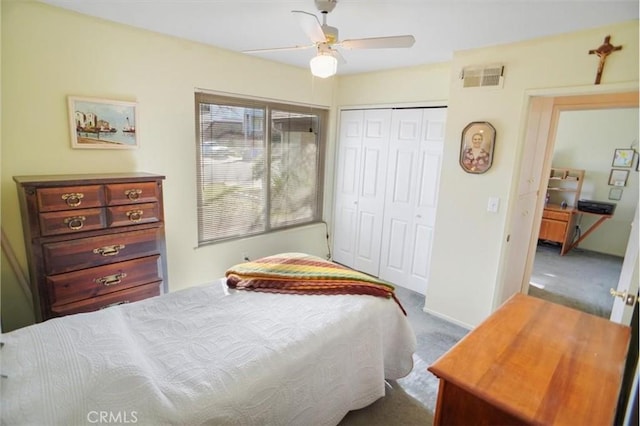 bedroom featuring ceiling fan, a closet, and carpet