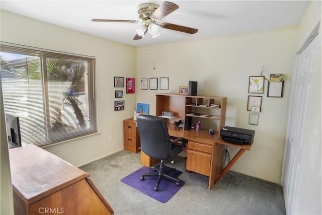 office space with light colored carpet and ceiling fan