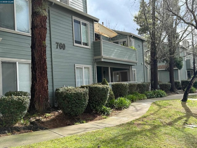 view of side of property with a lawn