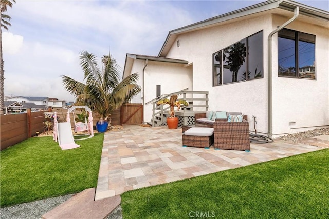 exterior space featuring a fenced backyard, a lawn, a patio, and stucco siding