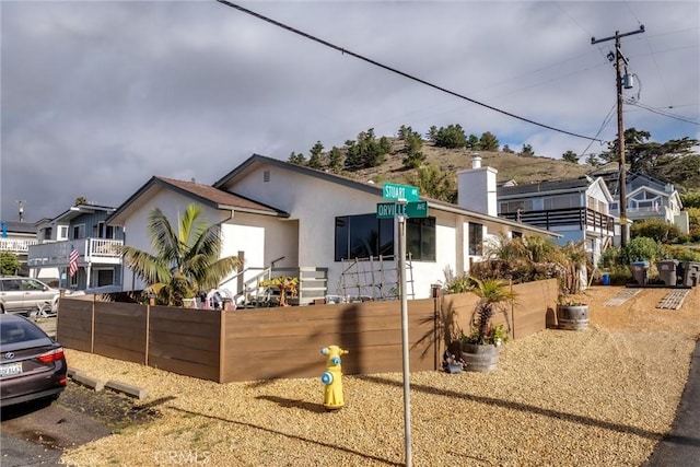 view of front of property with fence and stucco siding