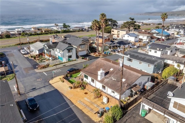 drone / aerial view with a beach view and a water view