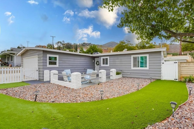 rear view of house with a patio and a yard