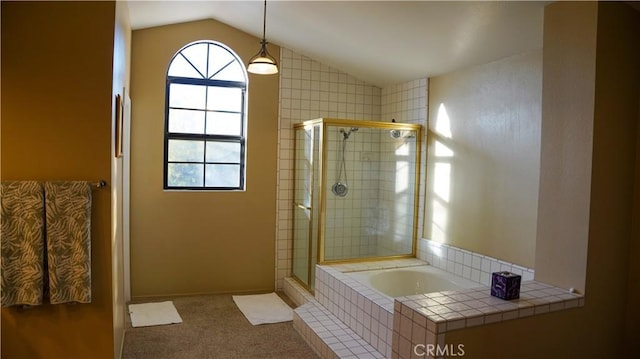 bathroom with lofted ceiling and independent shower and bath