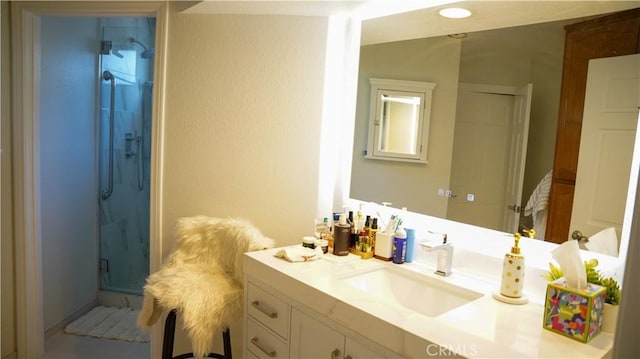 bathroom featuring vanity and an enclosed shower