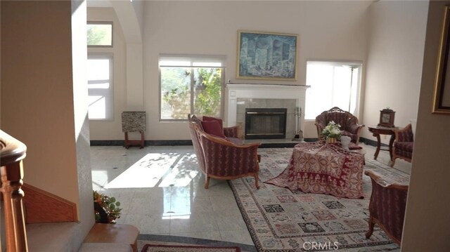 living room with a fireplace and tile patterned flooring