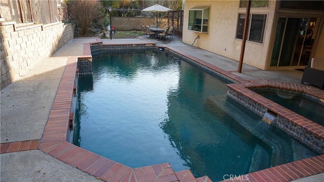 view of swimming pool with an in ground hot tub