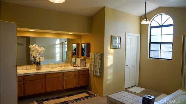 bathroom with vanity and vaulted ceiling