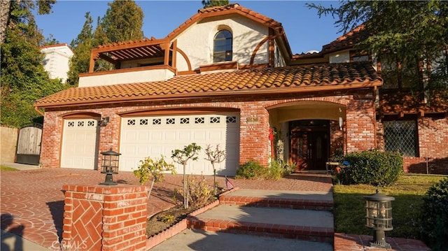 mediterranean / spanish house with a garage